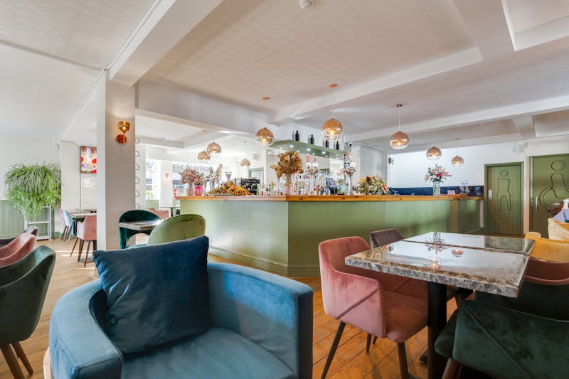 Stylish bar and lounge area at Dewey's Pizza with warm lighting